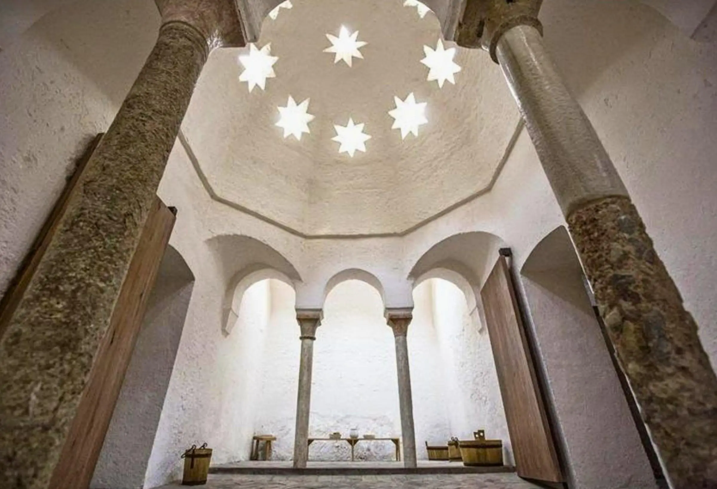 Eight-pointed star skylights in the vaulted ceiling of the Baños del Almirante