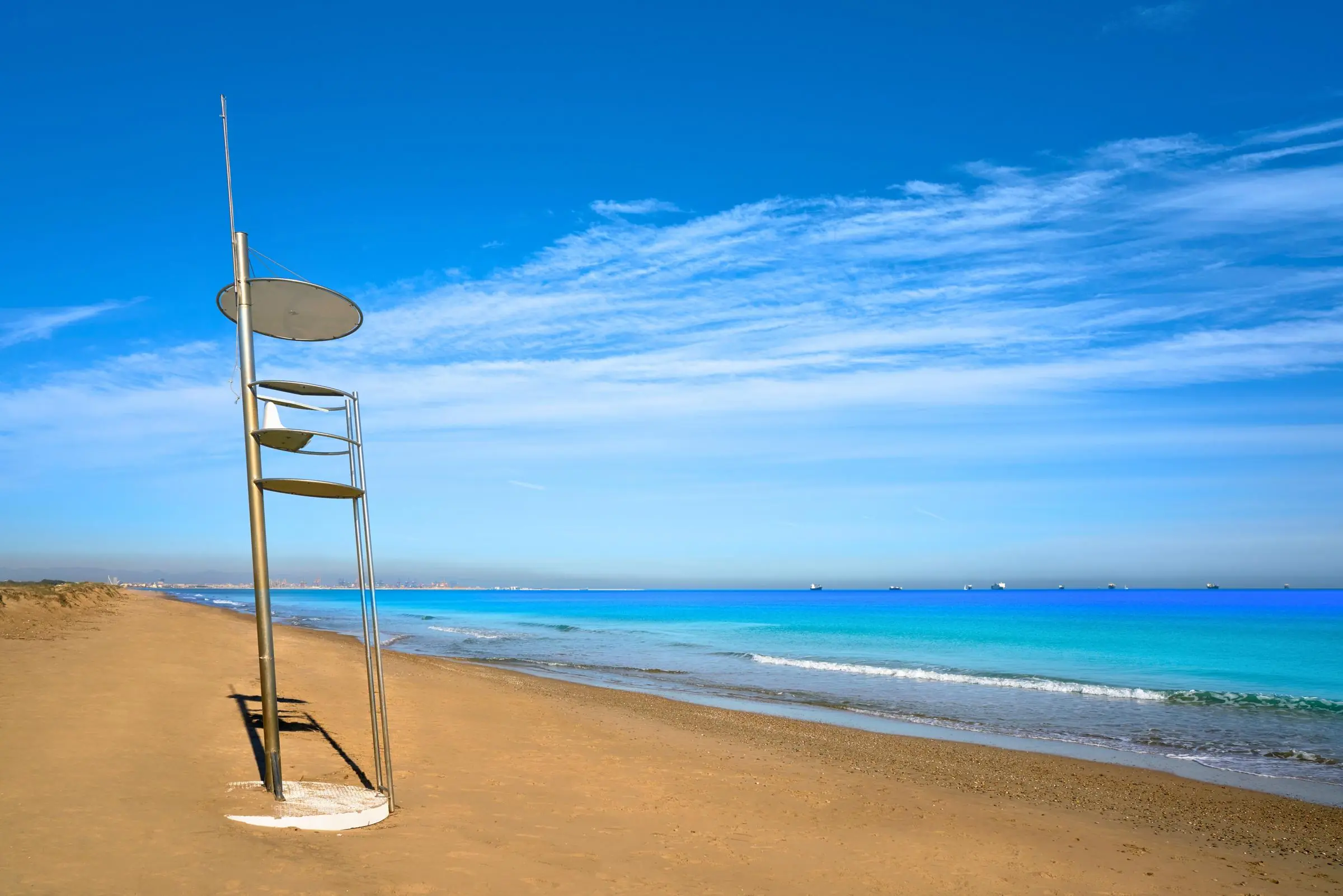 El Saler Beach A modern metal lifeguard tower on the wide golden sands of El Saler beach